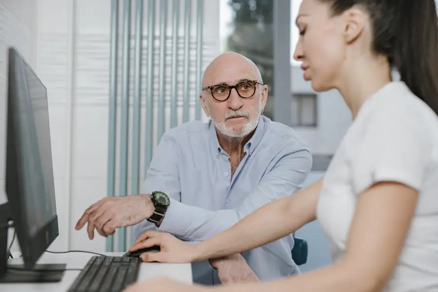 Elderly man receiving consultation from a medical practitioner in a modern indoor setting.